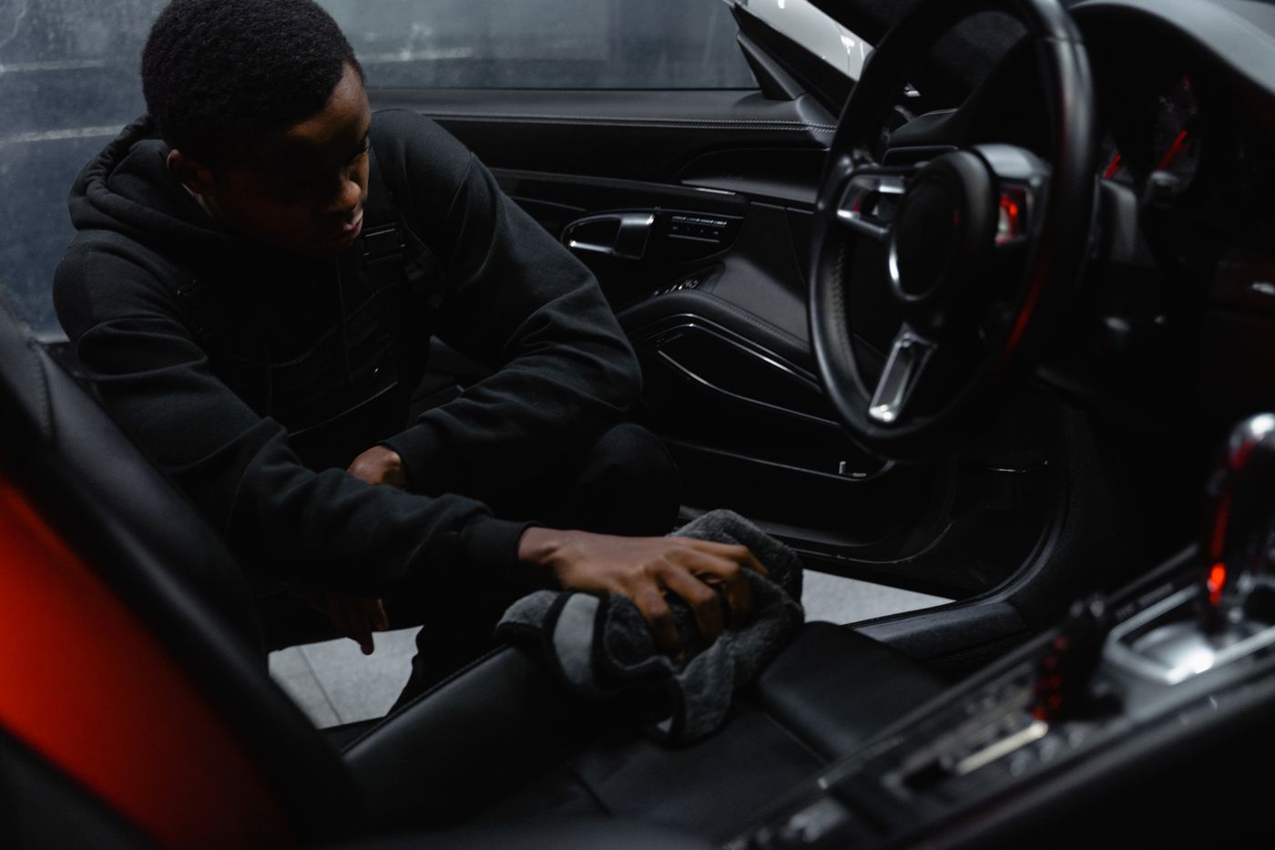 Technician cleaning the interior of a car